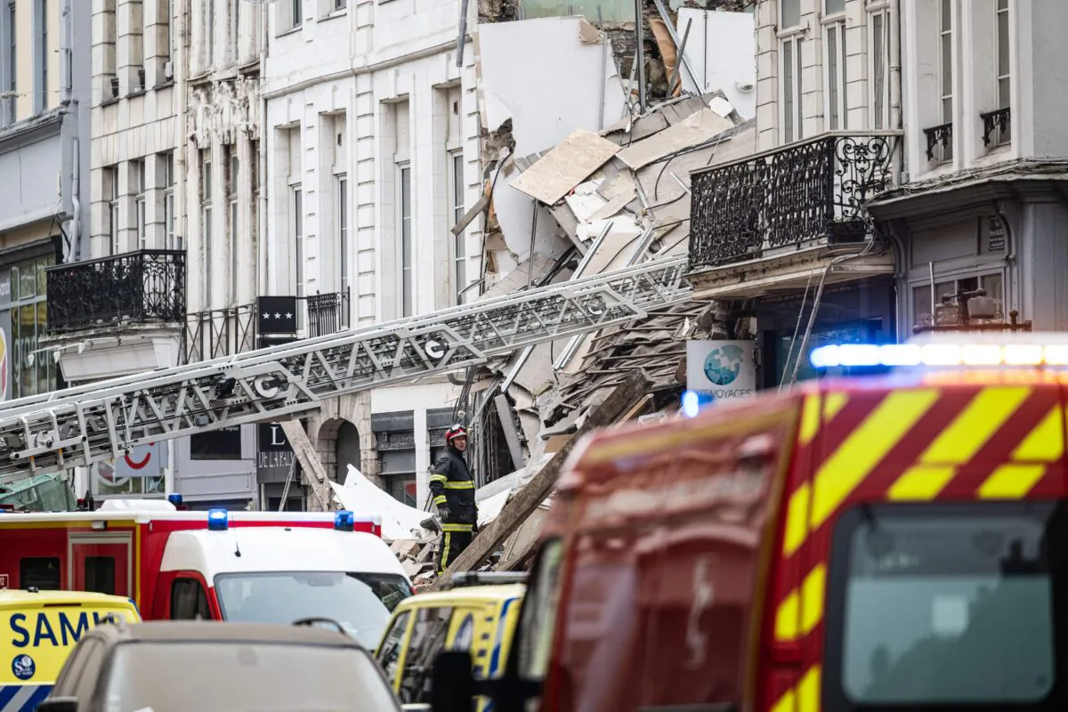 Firefighters inspect a collapsed building as they search for victims in the city of Lille, northern France, on Nov. 12, 2022. (Sameer Al-Doumy/AFP via Getty Images)