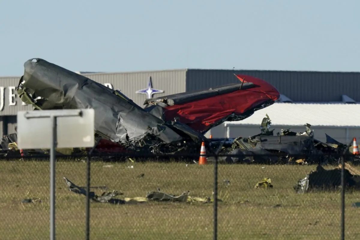Debris from two planes that crashed during an airshow at Dallas Executive Airport lie on the ground on Nov. 12, 2022. (LM Otero/AP Photo)