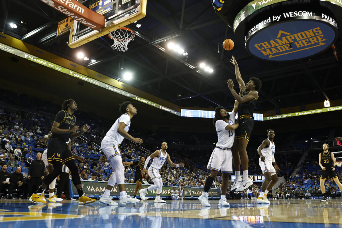 Chayce Polynice (13) of the Long Beach State 49ers attempts a shot against Tyger Campbell (10) of the UCLA Bruins during the second half of a game at UCLA Pauley Pavilion in Los Angeles, Nov. 11, 2022. (Michael Owens/Getty Images)