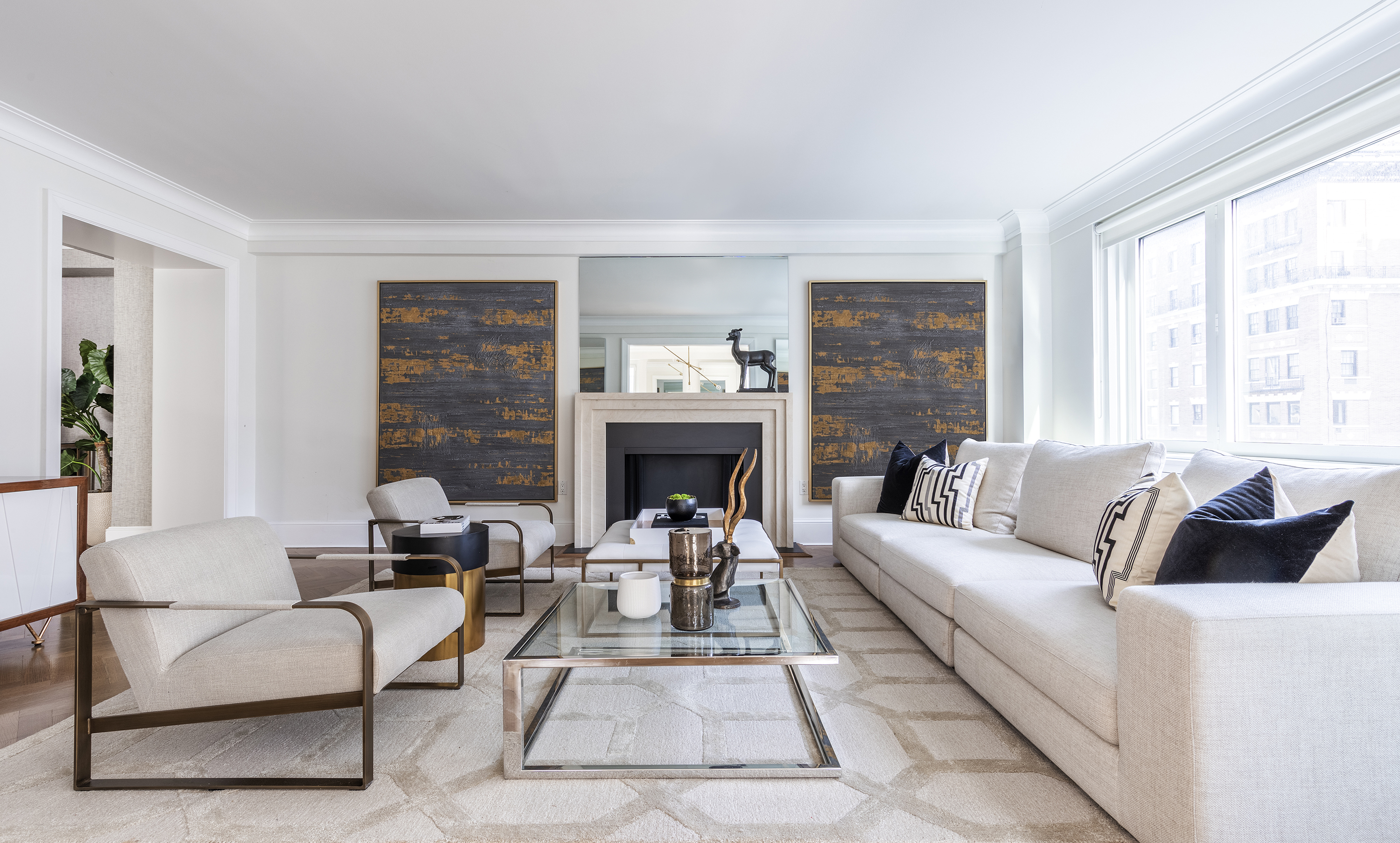 Black and gold artwork helps to ground and elevate this luxurious living space.