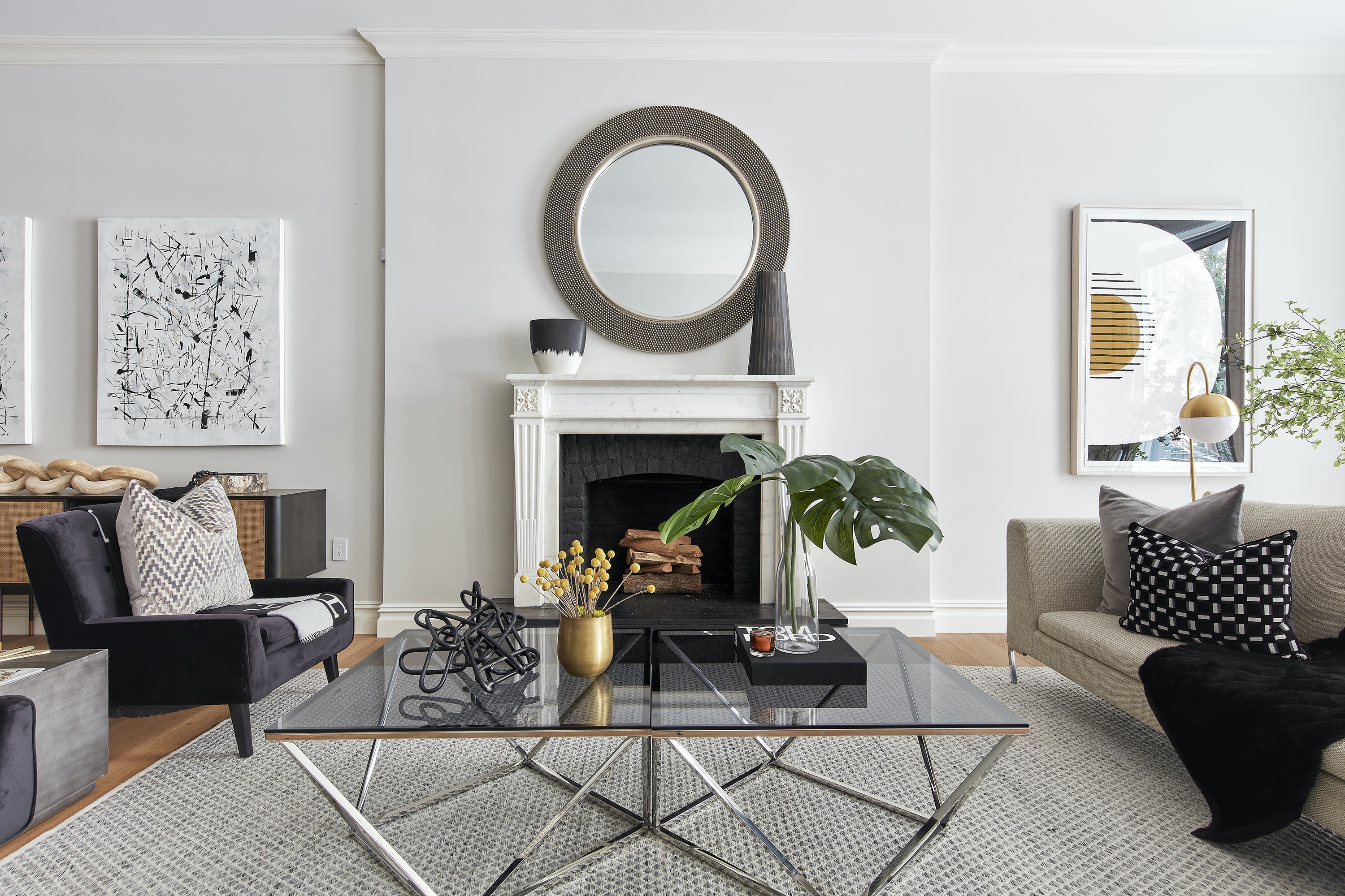 A dominant piece of art with black and gold serves as the springboard for a color palette in this living space.