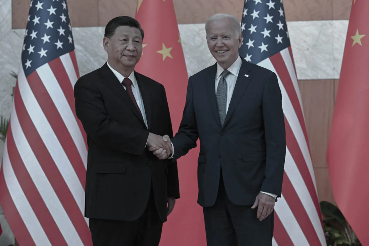 U.S. President Joe Biden and Chinese leader Xi Jinping shake hands as they meet on the sidelines of the G-20 summit in Nusa Dua on the Indonesian resort island of Bali on Nov. 14, 2022. (Saul Loeb/AFP via Getty Images)