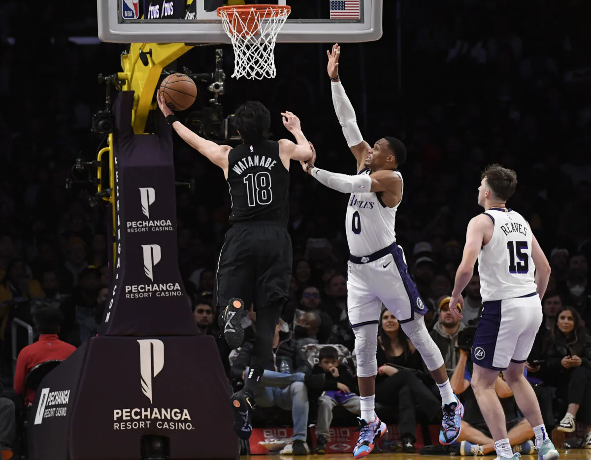 Yuta Watanabe (18) of the Brooklyn Nets scores a basket against Russell Westbrook (0) of the Los Angeles Lakers during the second half of the game at Crypto.com Arena in Los Angeles, Calif., on Nov. 13, 2022. (Kevork Djansezian/Getty Images)