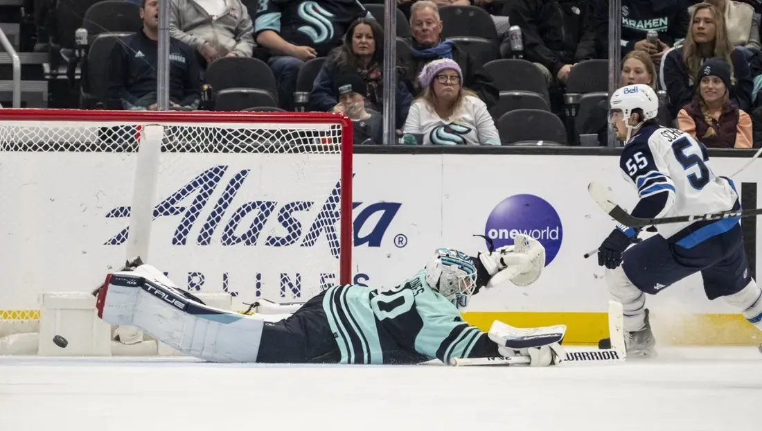 Winnipeg Jets forward Mark Scheifele (55) scores a goal in overtimve against Seattle Kraken goalie Martin Jones (30) at Climate Pledge Arena in Washington on Nov. 13, 2022. (Stephen Brashea/USA TODAY Sports via Field Level Media)