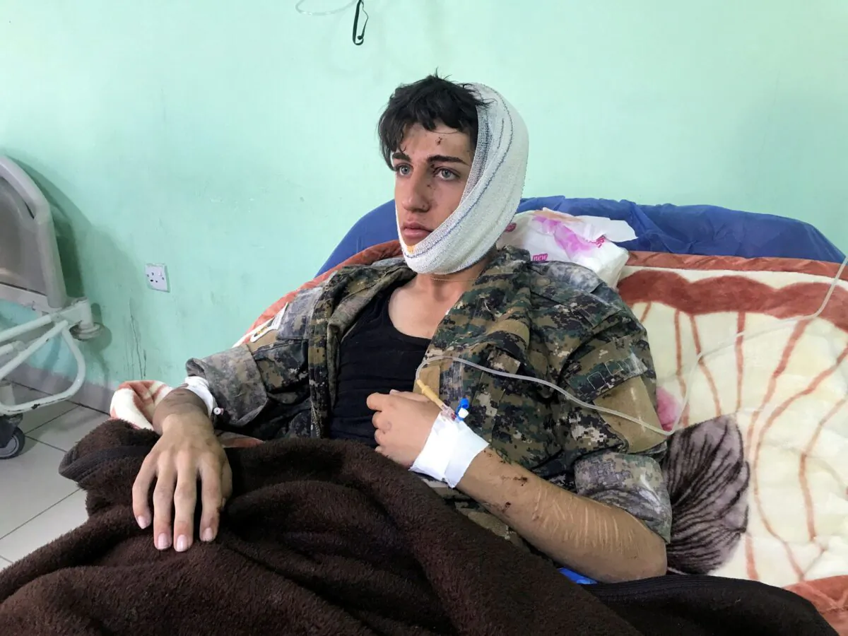 A wounded man lies in a hospital bed after rockets hit the headquarters of an Iranian Kurdish party in the city of Koye, near the capital of Iraq's autonomous Kurdish region Erbil, Iraq, on Nov. 14, 2022. (Azad Lashkari/Reuters)