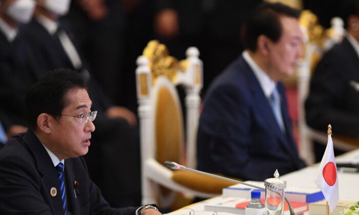 Japan's Prime Minister Fumio Kishida (L) and South Korea's President Yoon Suk-yeol (R) take part in the ASEAN-Plus Three Summit as part of the 40th and 41st Association of Southeast Asian Nations (ASEAN) Summits in Phnom Penh on Nov. 12, 2022. (TANG CHHIN SOTHY/AFP via Getty Images)