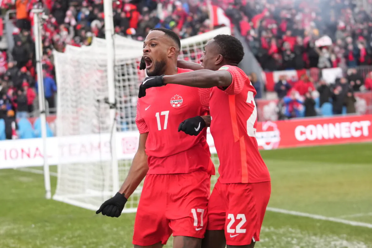 Canada's Cyle Larin (17) celebrates his goal with Richie Laryea against Jamaica during first-half CONCACAF World Cup soccer qualifying action in Toronto on March 27, 2022. Both are in Qatar preparing for the start of the World Cup on Nov. 23, 2022, when Canada plays against Belgium. (The Canadian Press/Nathan Denette)
