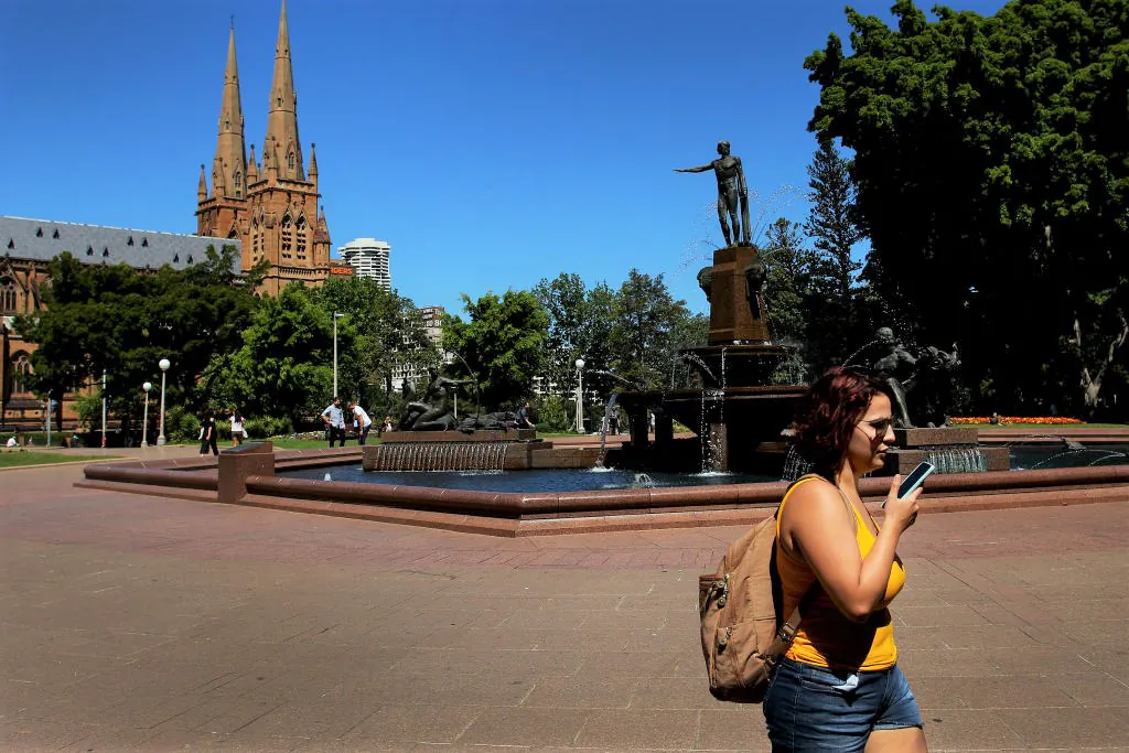 A woman talks on her phone as she walks through Hyde Park in Sydney, Australia on Oct. 22, 2019. (Lisa Maree Williams/Getty Images)