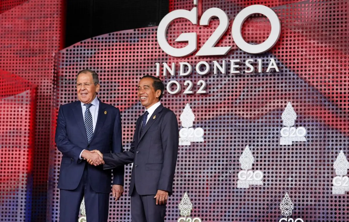Russian Foreign Minister Sergei Lavrov (L) shakes hands with Indonesia's President Joko Widodo as he arrives for the G20 leaders' summit in Nusa Dua, on the Indonesian resort island of Bali on Nov. 15, 2022. (Kevin Lamarque/POOL/AFP via Getty Images)
