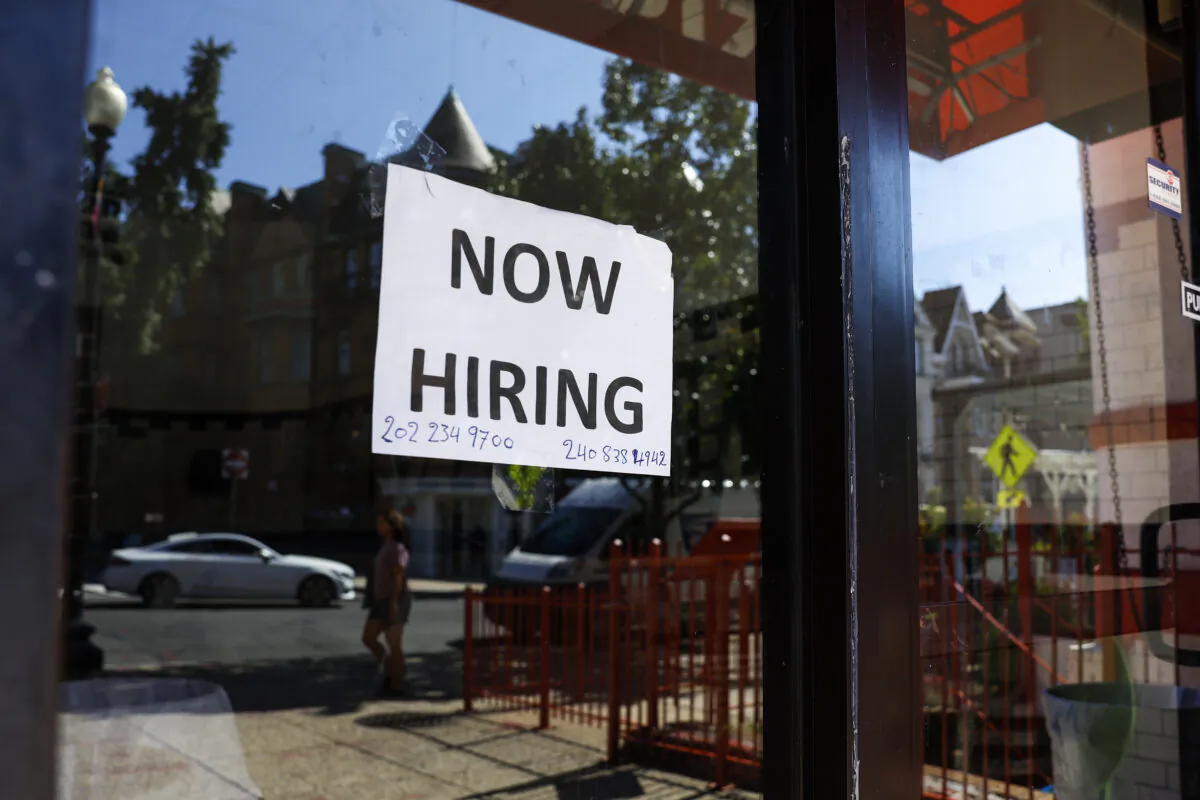 A 'Now Hiring' sign is displayed on a storefront in Adams Morgan neighborhood in Washington, on Oct. 7, 2022. (Anna Moneymaker/Getty Images)