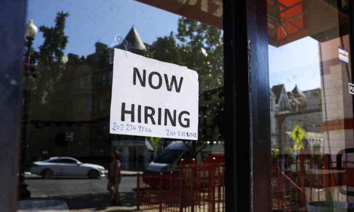 A "Now Hiring" sign is displayed on a storefront in Washington, on Oct. 7, 2022. (Anna Moneymaker/Getty Images)