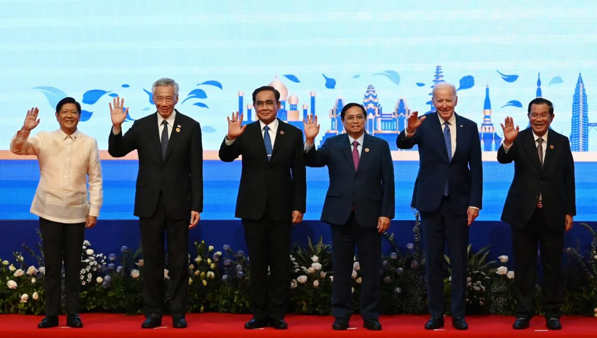 (L-R) Philippines' President Ferdinand Marcos Jr, Singapore's Prime Minister Lee Hsien Loong, Thailand's Prayut Chan-O-Cha, Vietnam's Prime Minister Pham Minh Chinh, US President Joe Biden and Cambodia's Prime Minister Hun Sen wave as they pose for pictures during the ASEAN-US summit as part of the 40th and 41st Association of Southeast Asian Nations (ASEAN) Summits in Phnom Penh, Cambodia, on Nov. 12, 2022. (TANG CHHIN SOTHY/AFP via Getty Images)