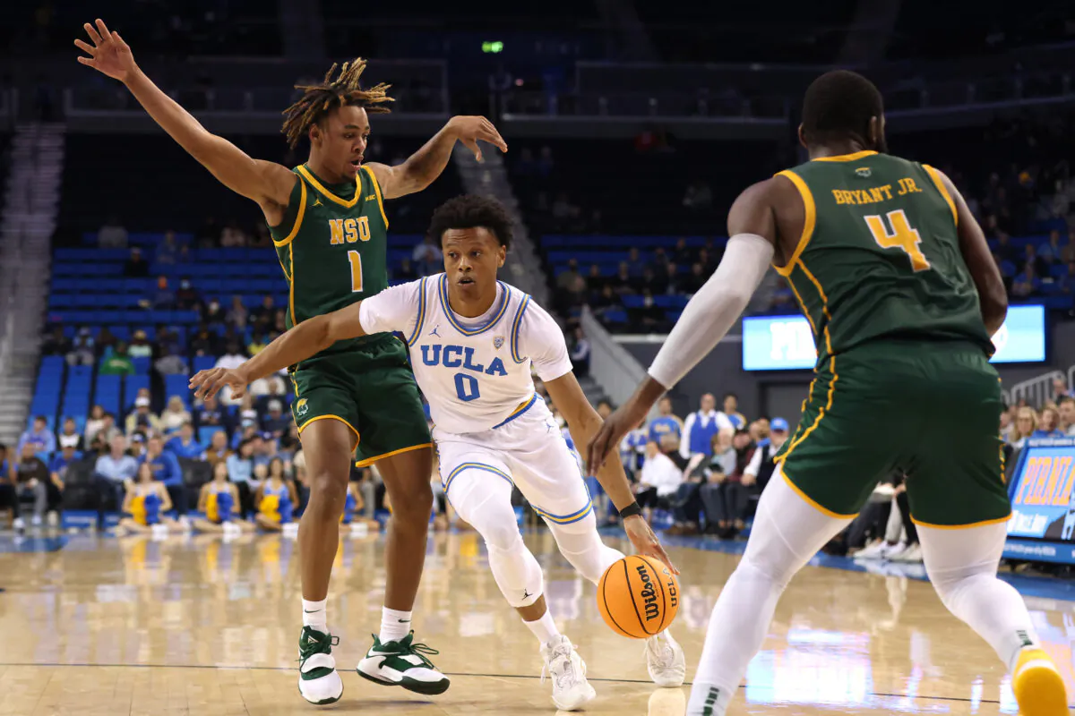Jaylen Clark (0) of the UCLA Bruins drives around George Beale (1) of the Norfolk State Spartans during the first half of a game at UCLA Pauley Pavilion in Los Angeles, on Nov. 14, 2022. (Katharine Lotze/Getty Images)