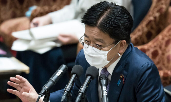 Japan's Minister of Health, Labour, and Welfare Katsunobu Kato, wearing a face mask, speaks during a budget committee meeting at the lower house of parliament on April 28, 2020 in Tokyo, Japan. (Tomohiro Ohsumi/Getty Images)