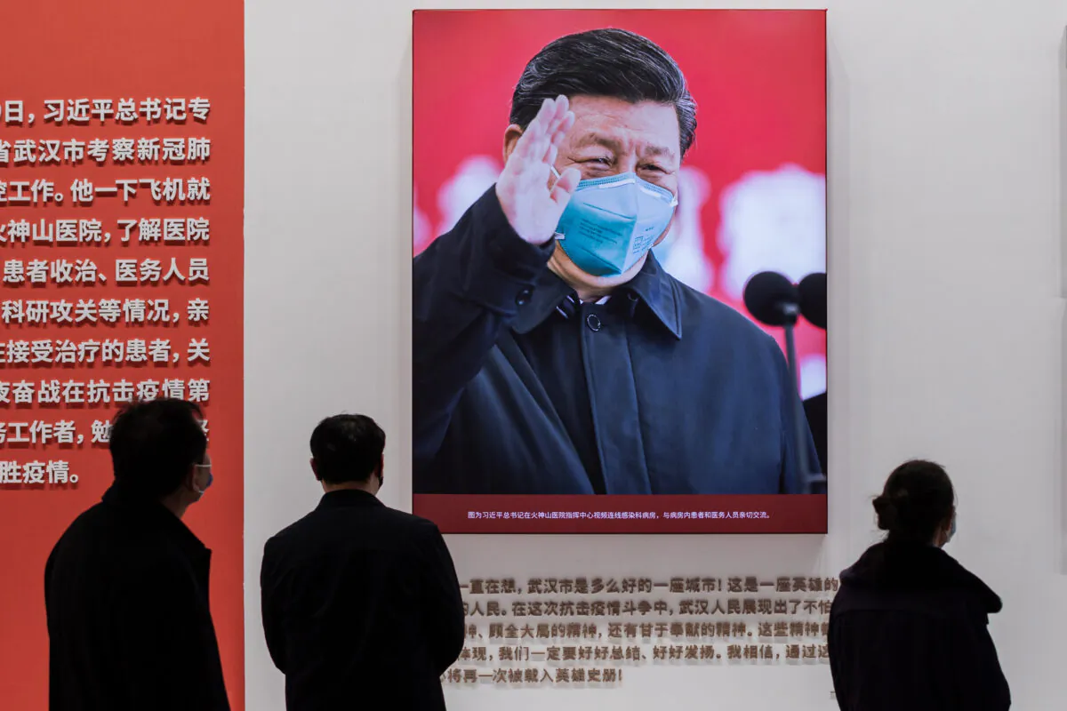 The picture of Chinese leader Xi Jinping with a mask is displayed at a convention center that was previously used as a makeshift hospital for patients in Wuhan, China, on Jan. 15, 2021. (Nicolas Asfouri/AFP via Getty Images)