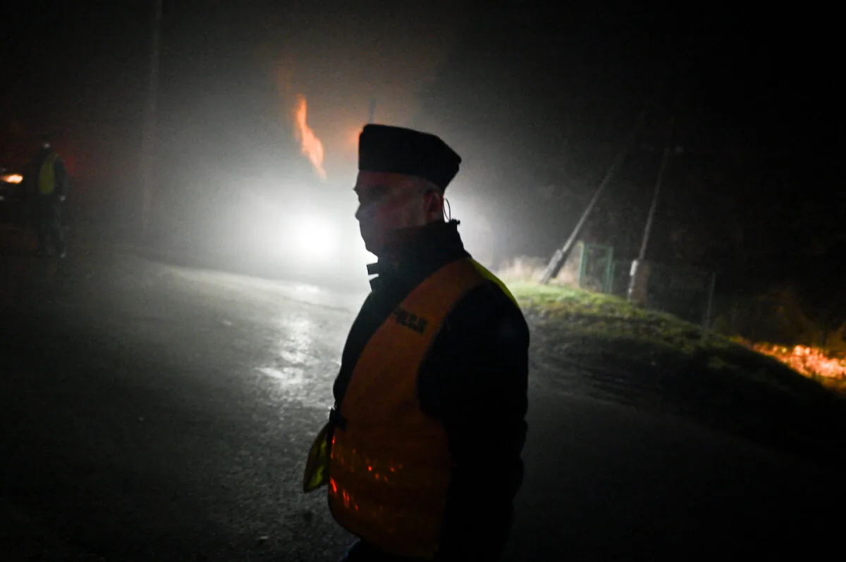 A police officer walks past a checkpoint on Nov. 16, 2022 in Przewodow, Poland, a day following reports a stray missile hit Polish territory killing two people. (Omar Marques/Getty Images)