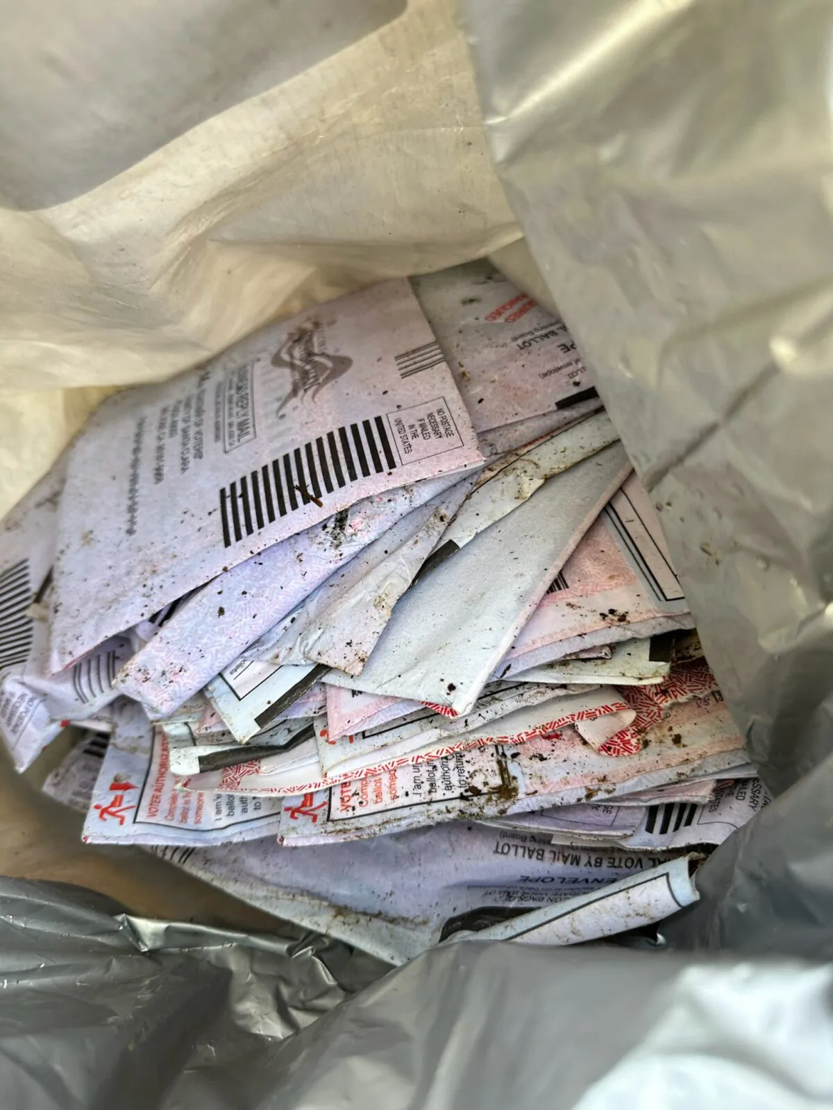 Mail-in ballots that Julie Ann Nieman found discarded near Highway 17 in the Santa Cruz Mountains in Calif. on Nov. 10–11, 2022. (Courtesy of Julie Ann Nieman)