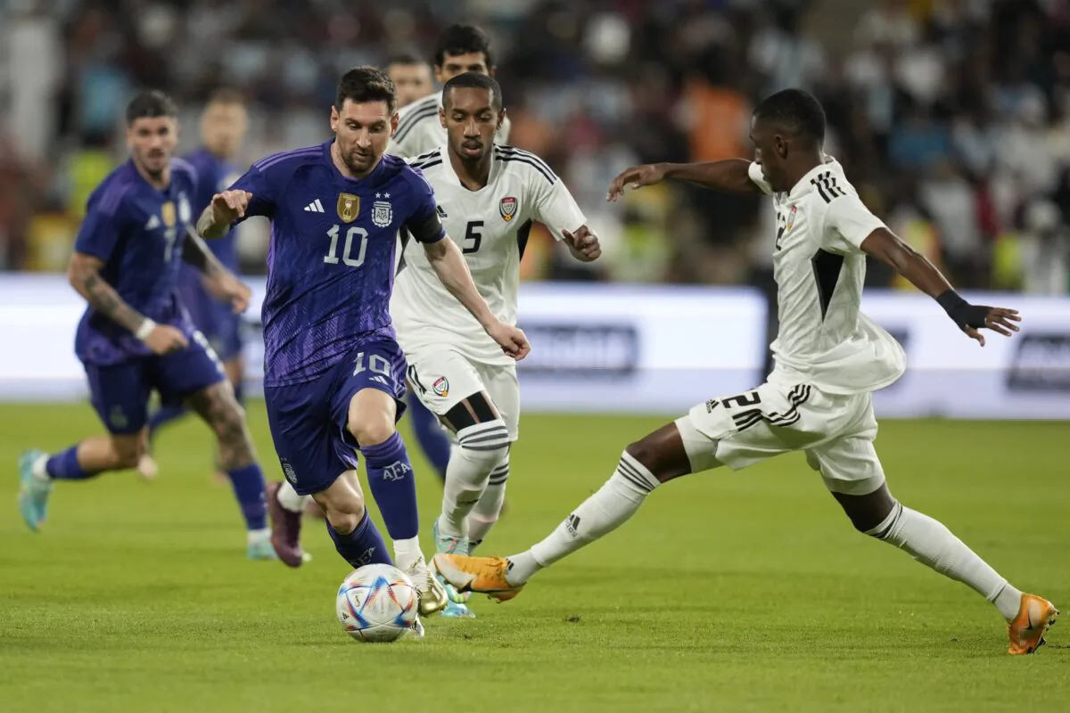 Argentina's Lionel Messi (L) and Khalifa Alhammadi of the United Arab Emirates fight for the ball during a friendly soccer match between Argentina and United Arab Emirates in Abu Dhabi on Nov. 16, 2022. (Kamran Jebreili/AP Photo)