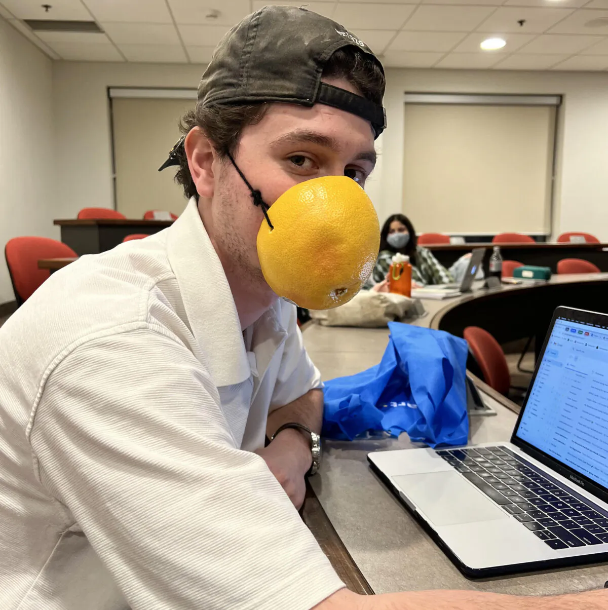 Kamil Bachouchi, a student at Wilfrid Laurier University, is protesting the school's mandatory masking policy in class by wearing a hollowed-out grapefruit. (Courtesy of Kamil Bachouchi)