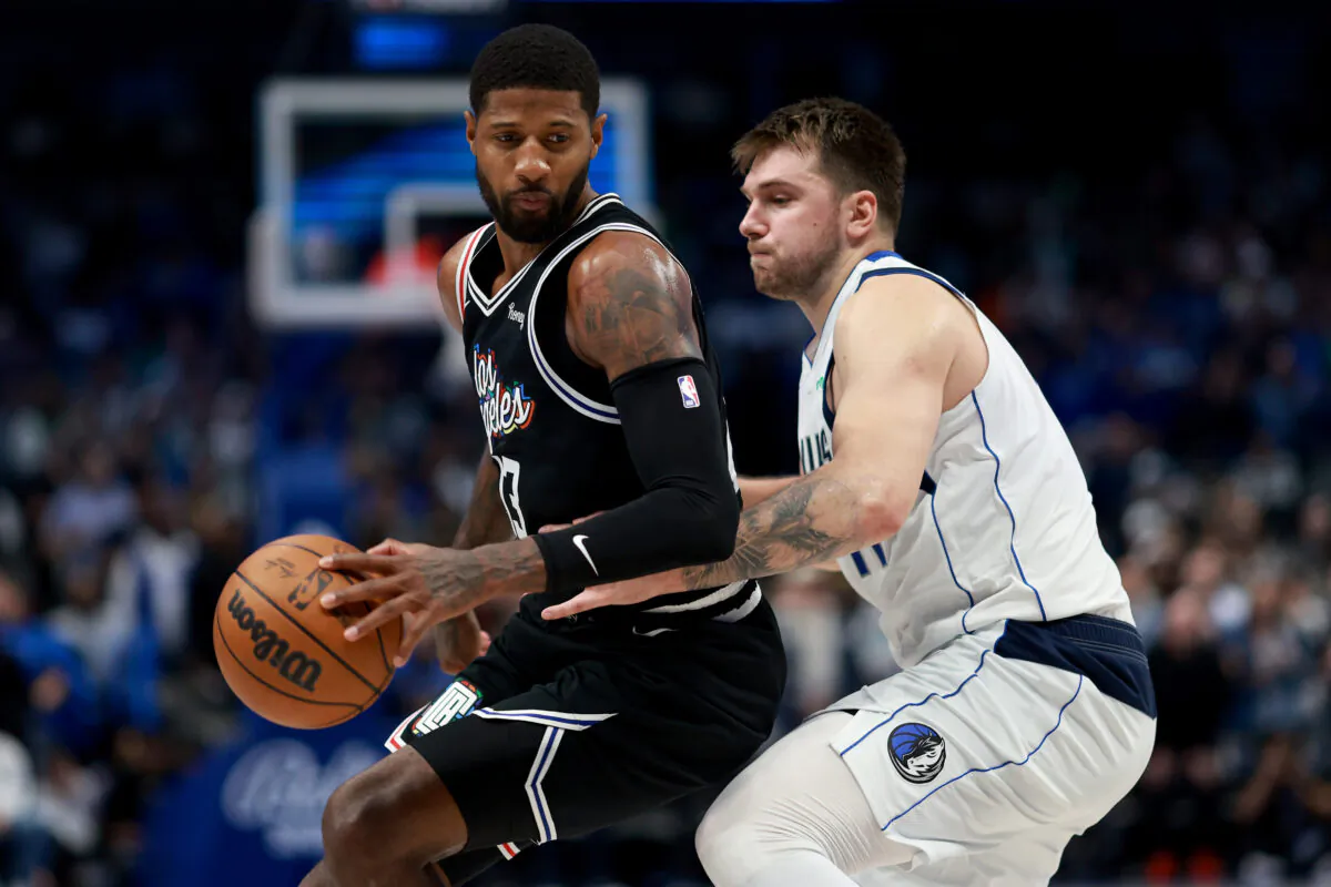 Paul George (13) of the LA Clippers drives to the basket against Luka Doncic (77) of the Dallas Mavericks in the fourth quarter at American Airlines Center in Dallas, on Nov. 15, 2022. (Tom Pennington/Getty Images)