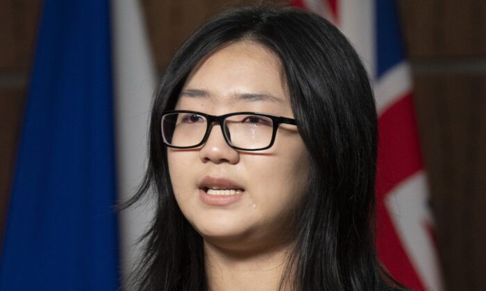 A tear rolls down her cheek as Katherine Dong speaks during a news conference for the release of her father Dong Guangping, on Parliament Hill, Nov. 17, 2022 in Ottawa. (The Canadian Press/Adrian Wyld)
