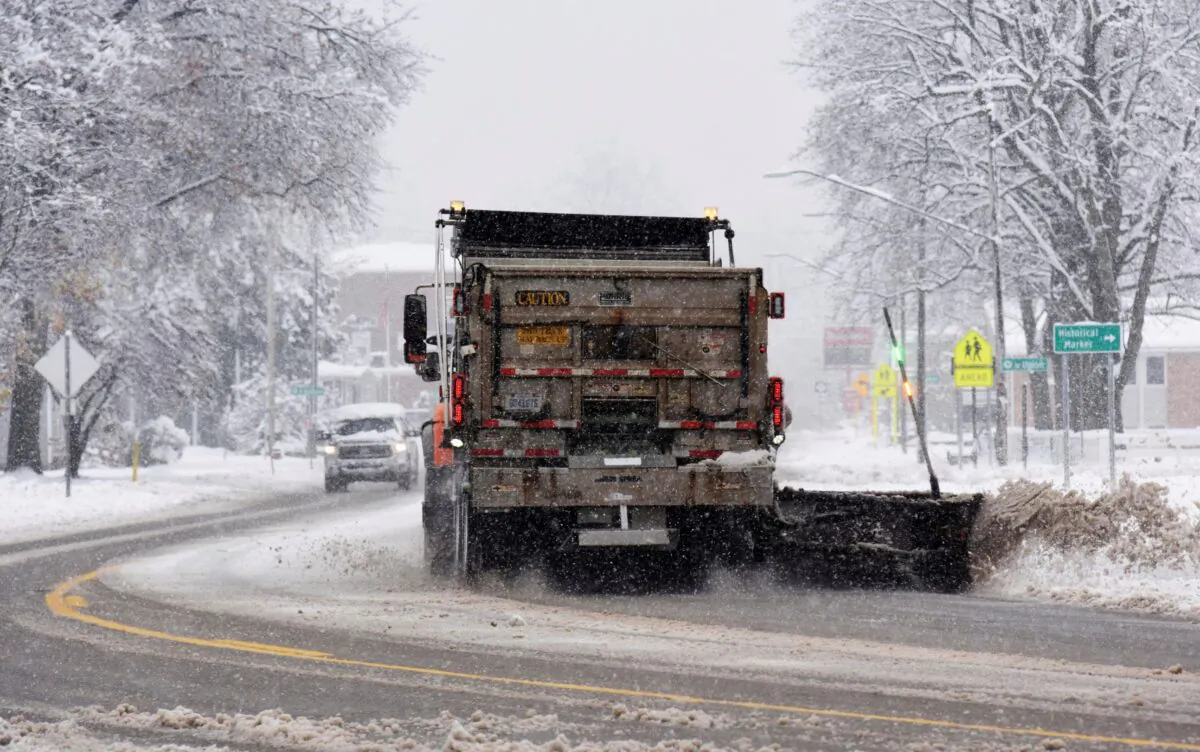 A Michigan Dept. of Transportation snowplow clears a section of M-139 during a late fall snowstorm, near downtown Berrien Springs, Mich., on Nov. 16, 2022. (Don Campbell/The Herald-Palladium via AP)