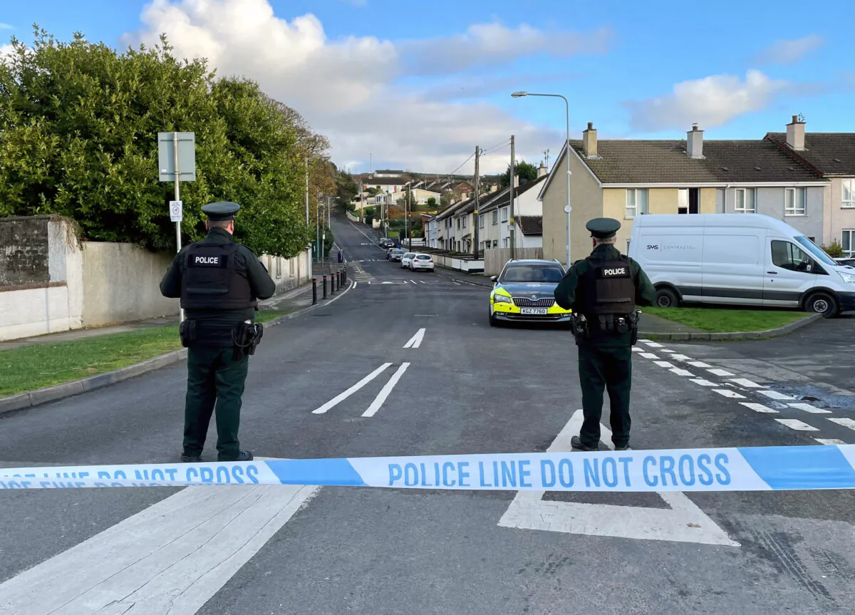 Officers from the Police Service of Northern Ireland (PSNI) stand guard at the scene, following the attempted murder of two officers in Strabane, Northern Ireland, on Nov. 18, 2022. (David Young/PA via AP)