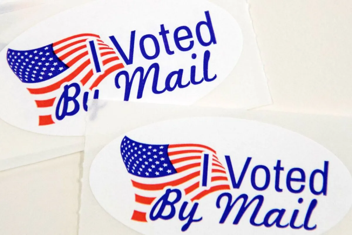 Stickers that read "I Voted By Mail" sit on a table waiting to be stuffed into envelopes by absentee ballot election workers  at the Mecklenburg County Board of Elections office in Charlotte, N.C. on Sept. 4, 2020. (Logan Cyrus/AFP via Getty Images)