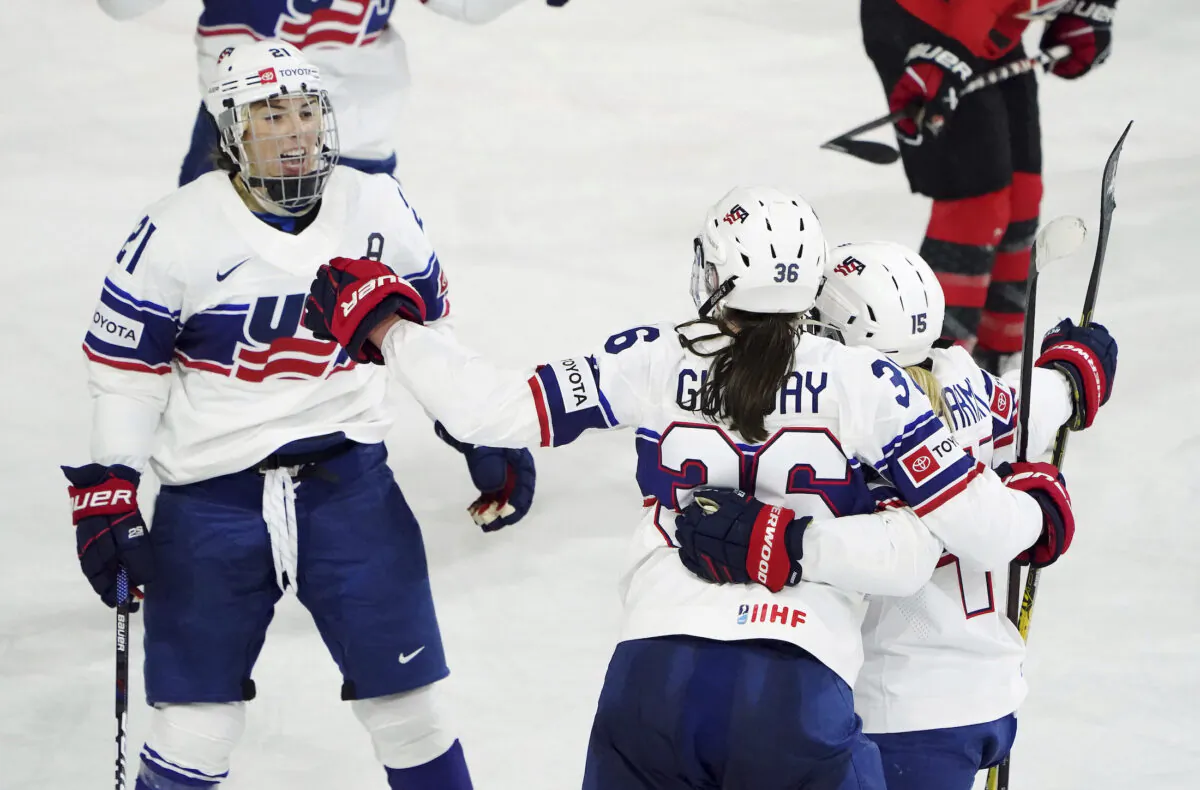 United States' Rory Guilday (36) celebrates her goal against Canada with Hilary Knight (21) and Savannah Harmon (15) during the second period of a Rivalry Series hockey game in Kamloops, British Columbia, on Nov. 17, 2022. (Jesse Johnston/The Canadian Press via AP)
