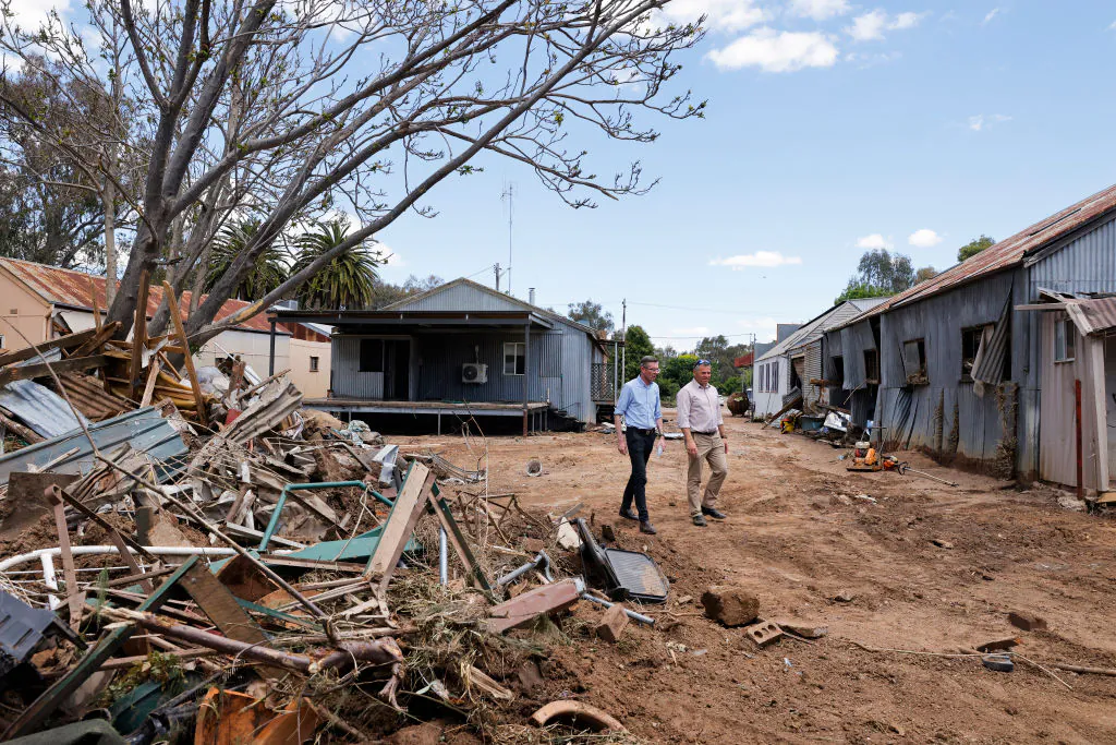 NSW Premier Dominic Perrottet (L) and State Member for Orange Philip Donato walk through flood damaged businesses on Nov. 18, 2022 in Eugowra, Australia. (Photo by Jenny Evans/Getty Images)