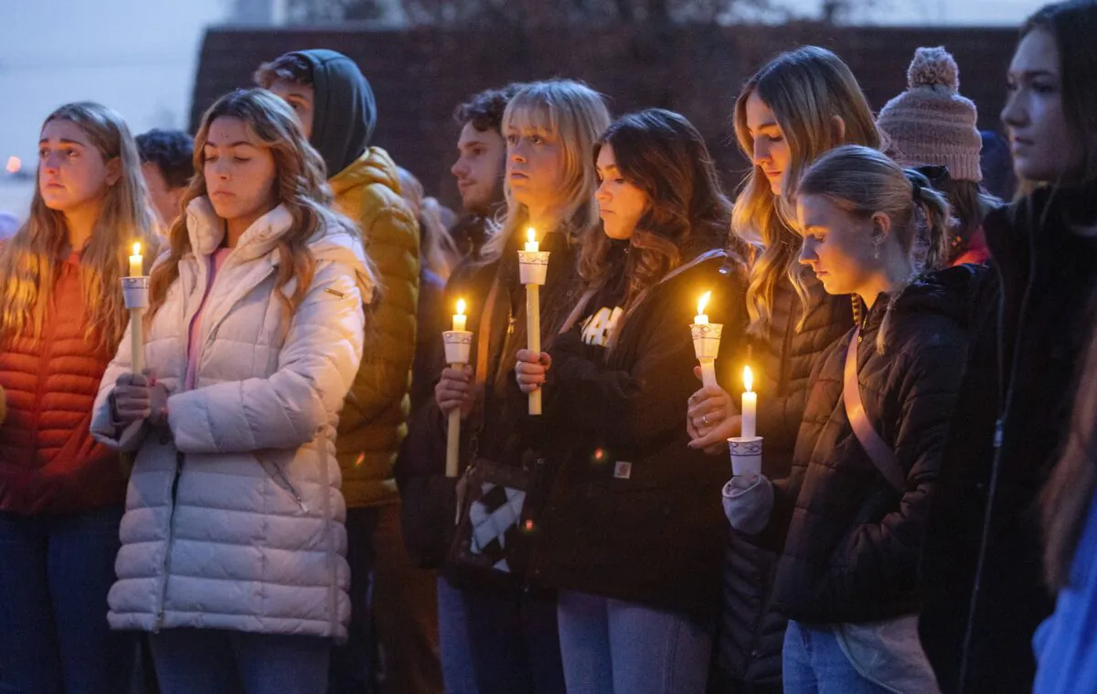 Boise State University students, along with people who knew the four University of Idaho students who were found killed in Moscow, Idaho, days earlier, pay their respects at a vigil held in front of a statue on the Boise State campus in Boise, Idaho, on Nov. 17, 2022. (Sarah A. Miller/Idaho Statesman via AP)