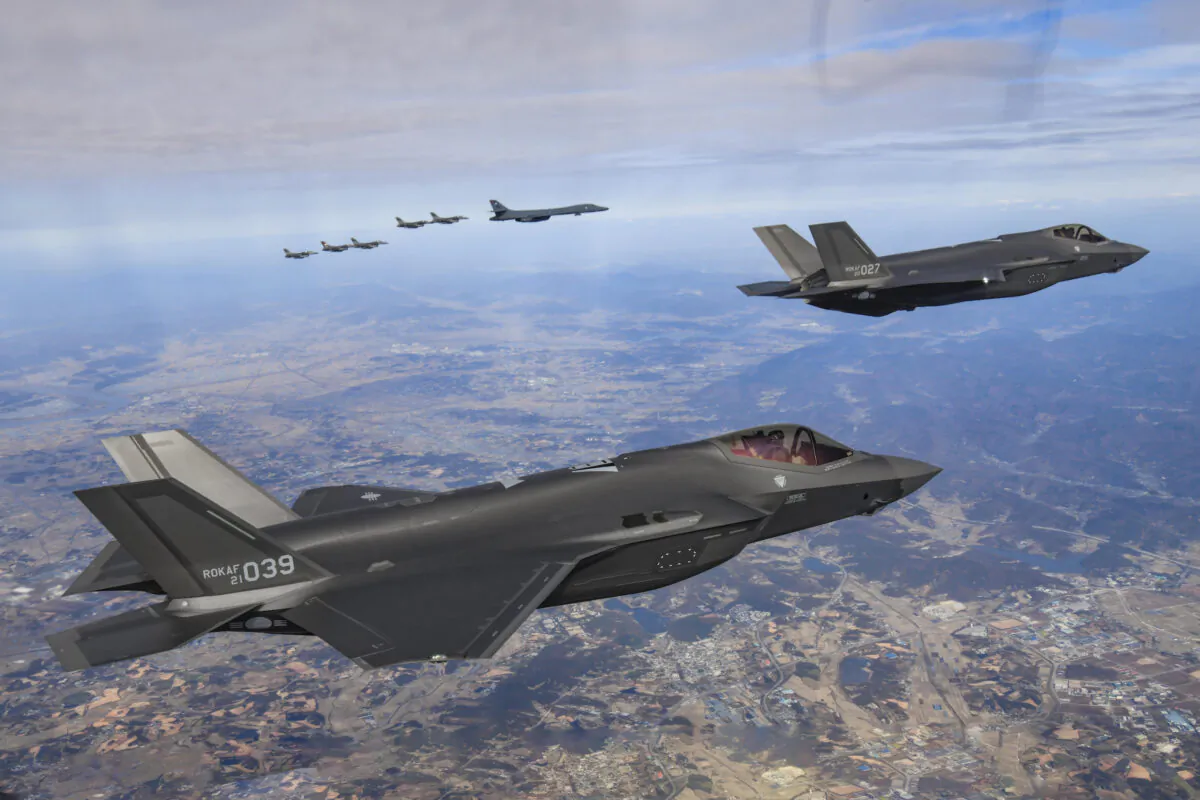 A  U.S. Air Force B-1B bomber, sixth from top left, South Korean Air Force F-35 fighter jets and US Air Force F-16 fighter jets, left, fly over South Korea Peninsula during a joint air drill in South Korea, on Nov. 19, 2022. (South Korean Defense Ministry via AP)