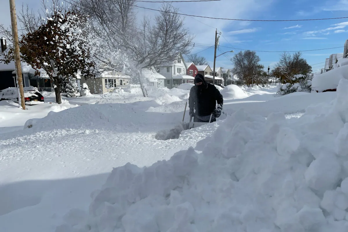 Martin Haslinger uses a snowblower outside his home in Buffalo, N.Y., on Nov. 19, 2022. (Bridget Haslinger via AP)
