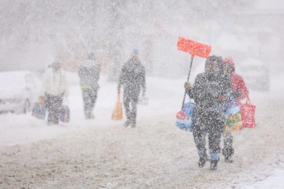 Residents walk on the street during a snowstorm as extreme winter weather hits Buffalo, N.Y., on Nov. 18, 2022. (Lindsay DeDario/Reuters)