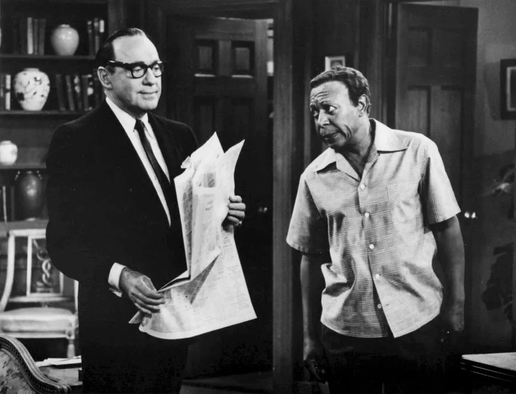 Comedian Jack Benny (L) in a 1977 skit with Eddie Anderson who played Benny's sidekick and valet Rochester. (Public Domain)