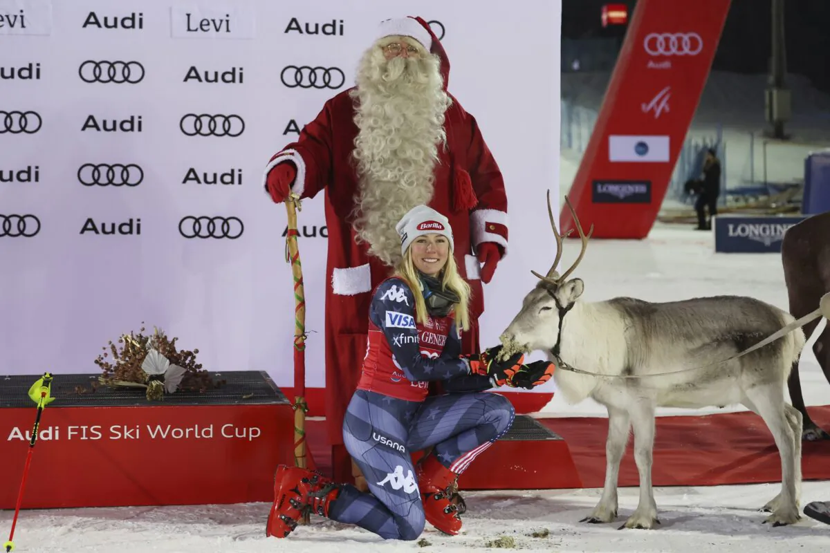 Mikaela Shiffrin of the United States poses with Santa Claus and a reindeer after winning an alpine ski, women's World Cup slalom, in Levi, Finland, on Nov. 20, 2022. (Alessandro Trovati/AP Photo)
