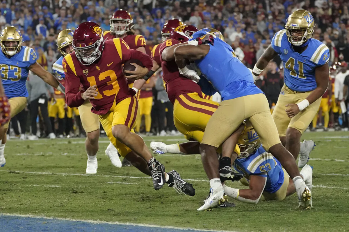 Southern California quarterback Caleb Williams (13) runs in for a touchdown during the first half of an NCAA college football game against UCLA in Pasadena, Calif., on Nov. 19, 2022. (Mark J. Terrill/AP Photo)