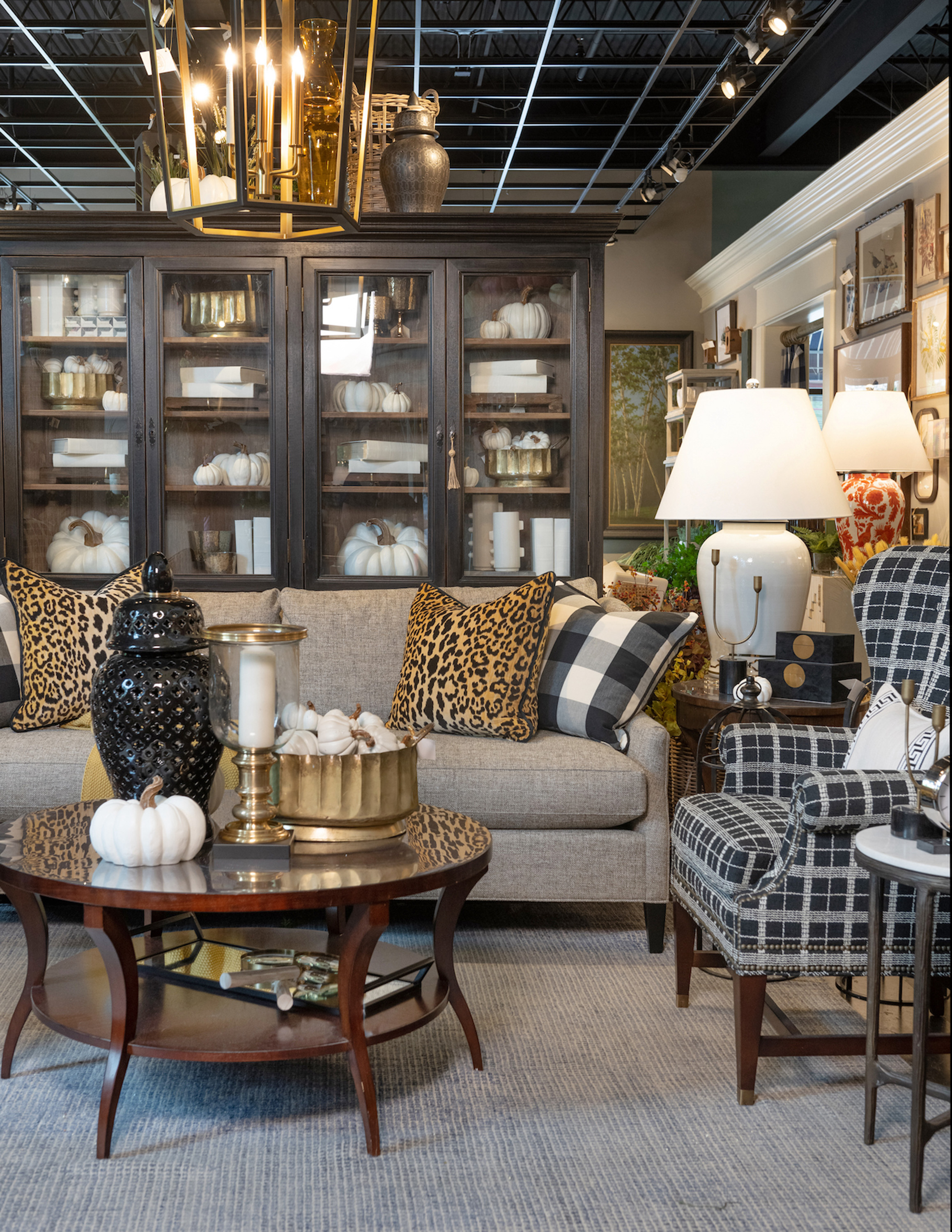 Buffalo plaid pillows and a black and white plaid chair mix and match beautifully in this stately room.