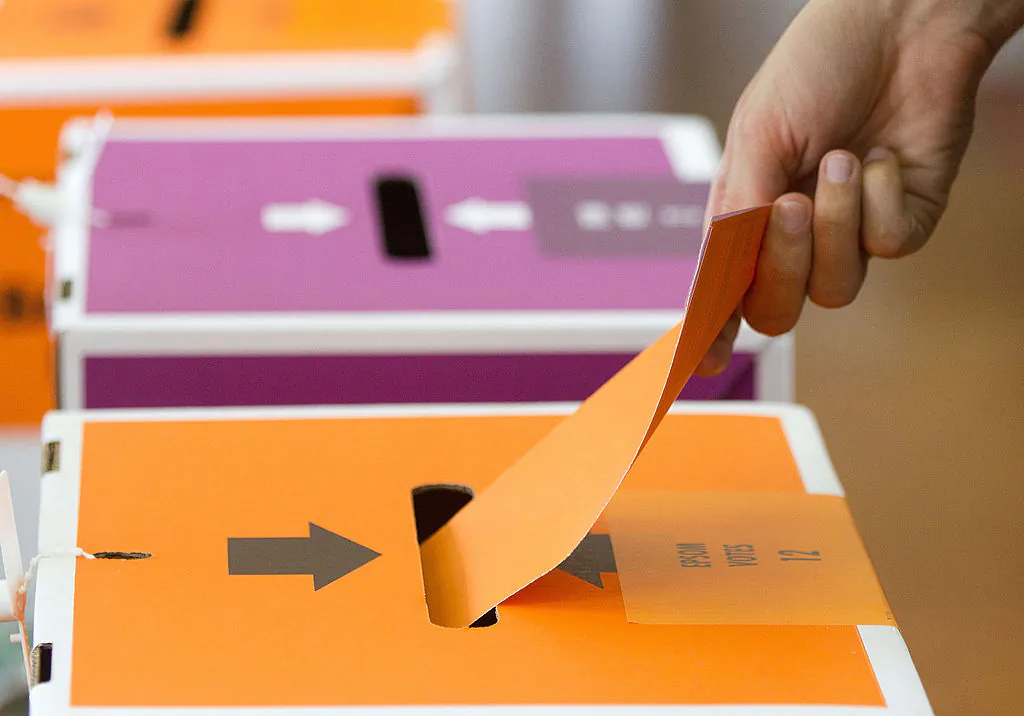 A voter casts his ballot during the general election at a polling center in Auckland, New Zealand, on Nov. 26, 2011. (Marty Melville/AFP via Getty Images)
