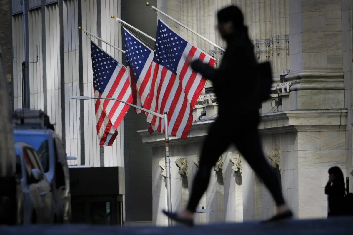 A pedestrian walks past the New York Stock Exchange in New York on Oct. 27, 2022. (J. David Ake/AP Photo)