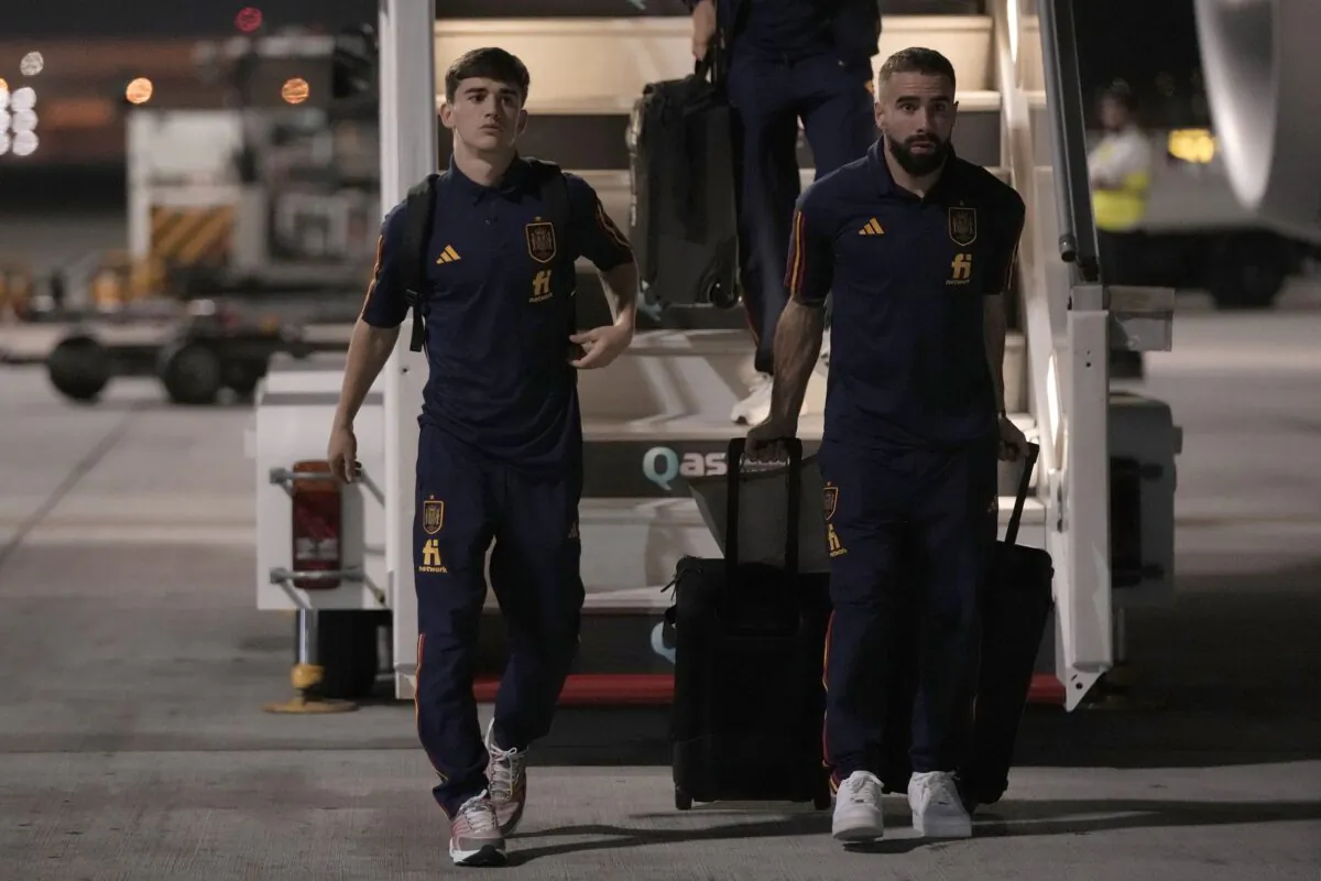 Gavi, (L), and Dani Carvajal of Spain's national soccer team arrive with teammates at Hamad International airport in Doha, Qatar, on Nov. 18, 2022, ahead of the upcoming World Cup. (Hassan Ammar/AP Photo)