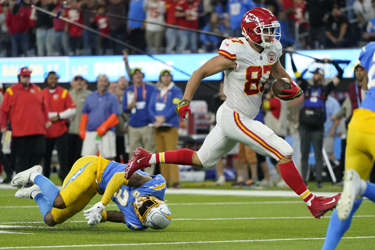 Kansas City Chiefs tight end Travis Kelce, right, runs in for a touchdown as Los Angeles Chargers safety Derwin James Jr. falls during the second half of an NFL football game in Inglewood, Calif., on Nov. 20, 2022, (Jae C. Hong/AP Photo)