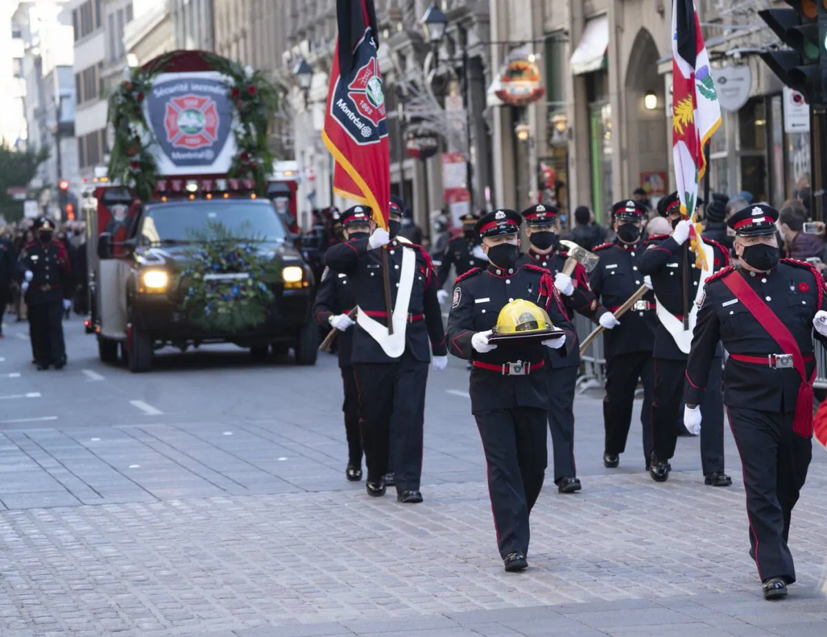 The procession arrives at the church for funeral services for fireman Pierre Lacroix in Montreal, Oct. 29, 2021. (The Canadian Press/Ryan Remiorz)
