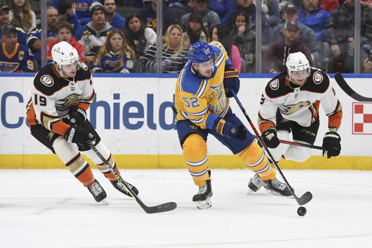 St. Louis Blues center Noel Acciari (52) works the puck against Anaheim Ducks' Troy Terry (19) and Jakob Silfverberg (33) during the second period of an NHL hockey game in St. Louis, on Nov. 21, 2022. (Michael Thomas/AP Photo)