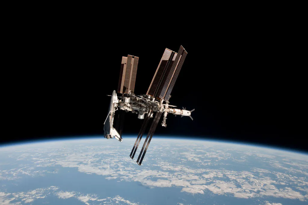 In this handout image provided by the European Space Agency (ESA) and NASA, the International Space Station and the docked space shuttle Endeavour orbit Earth during Endeavour's final sortie on May 23, 2011 in Space. (Paolo Nespoli - ESA/NASA via Getty Images)