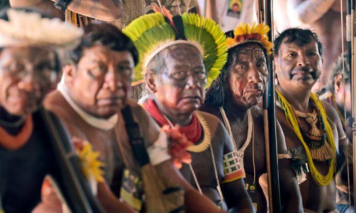 Indigenous tribesmen listen to their leader of the Kayapo tribe,  during a press conference in Piaracu village, near Sao Jose do Xingu, Mato Grosso state, Brazil, on Jan. 15, 2020.(Carl de Souza/AFP via Getty Images)