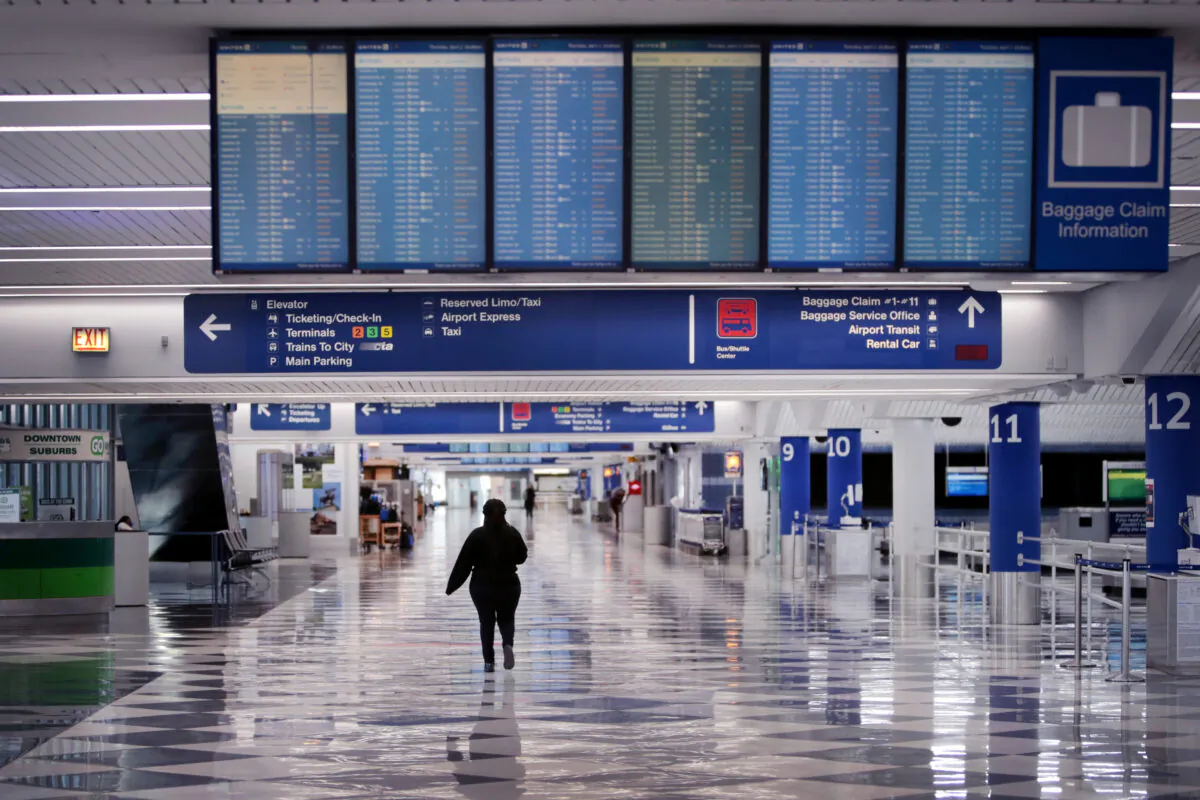 A worker walks through a baggage claim area at a nearly-empty O'Hare International Airport in Chicago, Ill., on April 2, 2020. (Scott Olson/Getty Images)