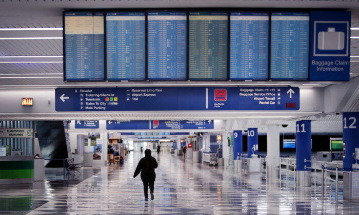 A worker walks through a baggage claim area at a nearly-empty O'Hare International Airport in Chicago, Ill., on April 2, 2020. (Scott Olson/Getty Images)