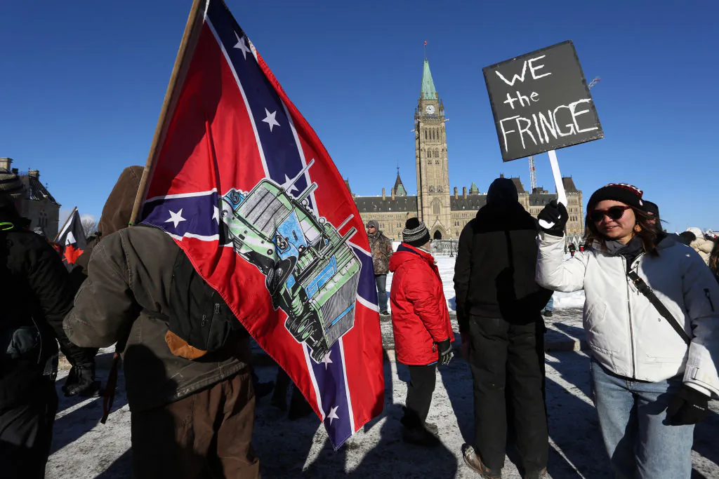 An individual carries a U.S. Confederate flag with an image of a truck on it during the Freedom Convoy protest in Ottawa on Jan. 29, 2022. (Dave Chan/AFP via Getty Images)