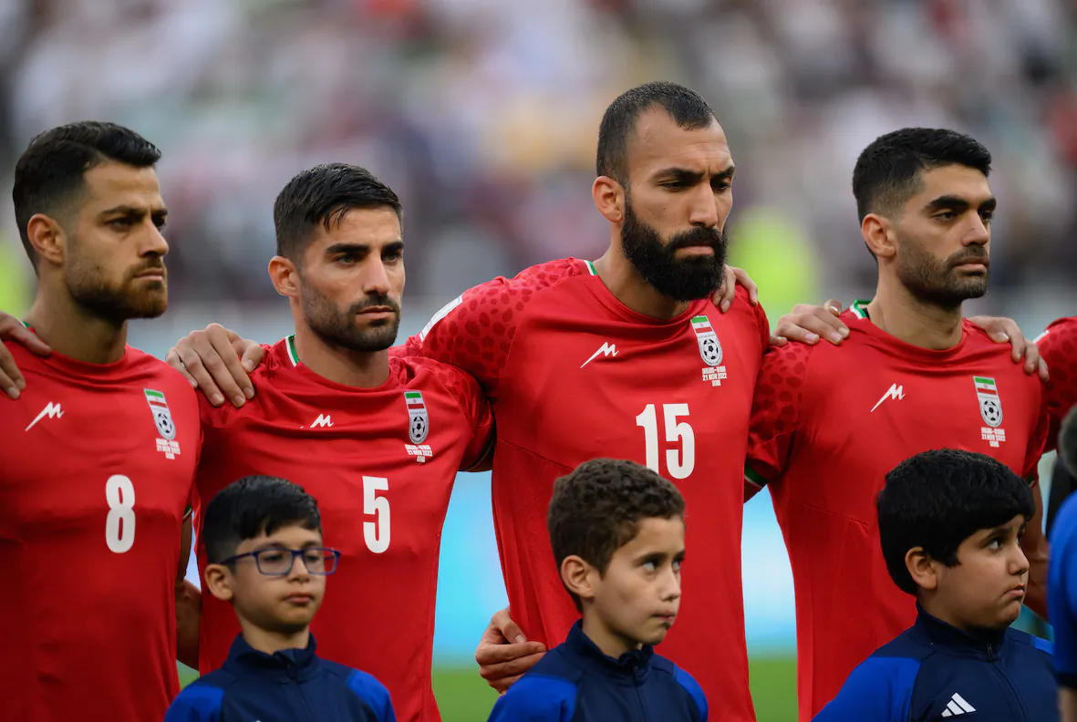 Morteza Pouraliganji, Milad Mohammadi, and Roozbeh Cheshmi of IR Iran line up for the national anthem prior to the FIFA World Cup Qatar 2022 Group B match between England and IR Iran at Khalifa International Stadium in Doha, Qatar, on Nov. 21, 2022. (Matthias Hangst/Getty Images)